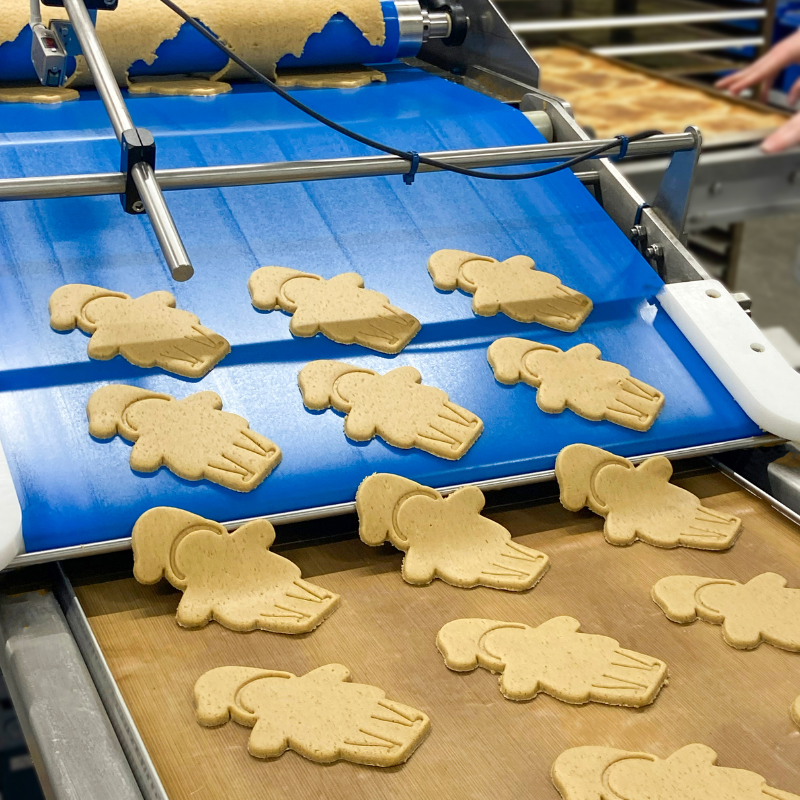 Original Biscuit Bakers Santa gingerbread biscuit dough being cut.