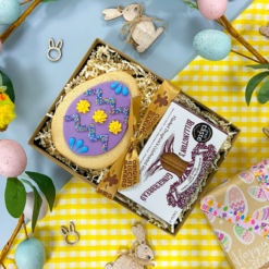 Original Biscuit Bakers Easter gift box with a decorated sugar cookie egg and Billington’s Gingerbread fingers, styled with pastel eggs and spring decorations.
