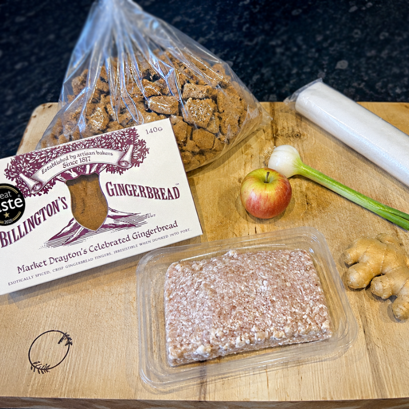 Billington’s gingerbread biscuits with sausage meat, apple, spring onion and fresh ginger on wooden board for sausage roll recipe