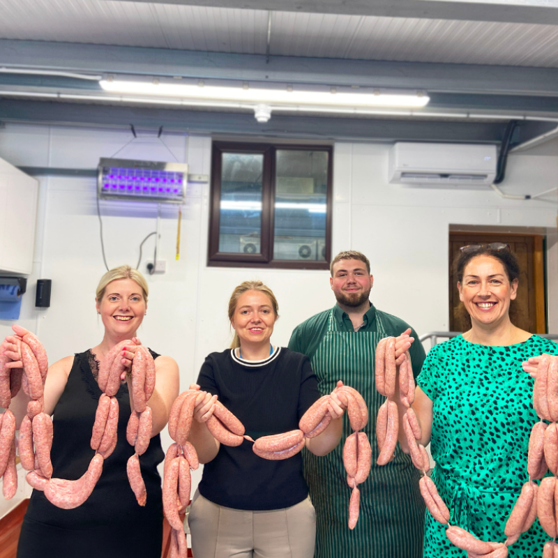 Team members from Billington's Gingerbread with the butcher from Fordhall Farm showcasing their made sausages.