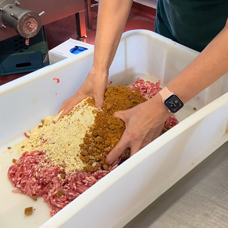 The ingredients of a sausage being combined.